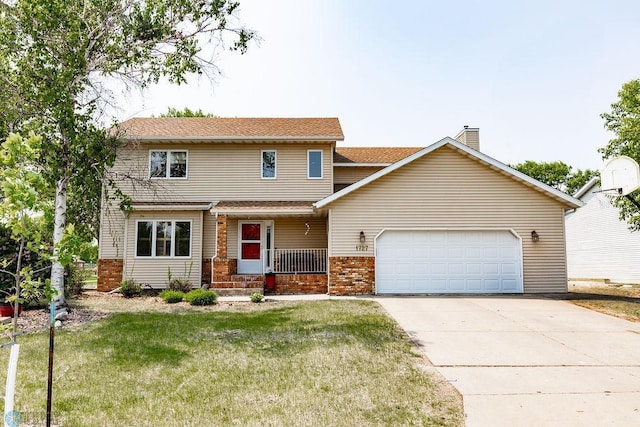 1727 33rd St S, Moorhead, MN 56560 - view of front of property featuring a garage, a front yard, brick siding, covered porch, and concrete driveway