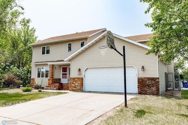 1727 33rd St S, Moorhead, MN 56560 - view of front of property with brick siding, a garage, concrete driveway, and a shingled roof