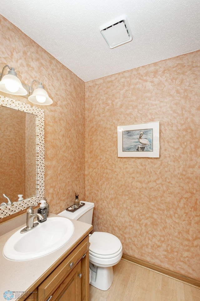 1727 33rd St S, Moorhead, MN 56560 - half bath with wood finished floors, toilet, vanity, and wallpapered walls