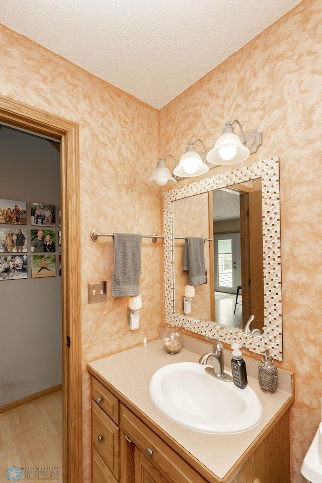 1727 33rd St S, Moorhead, MN 56560 - bathroom featuring vanity, wood finished floors, and a textured ceiling