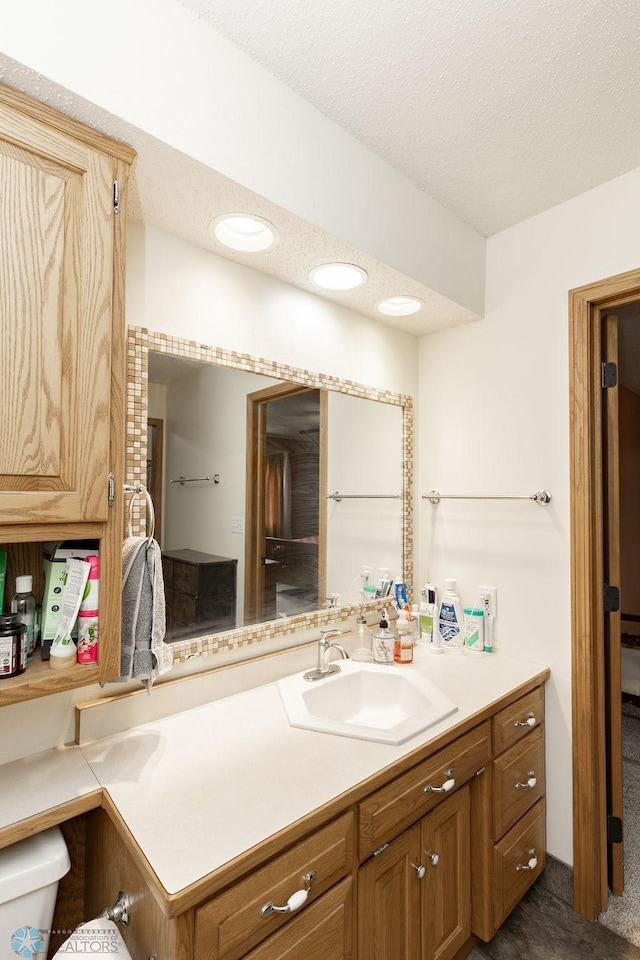 1727 33rd St S, Moorhead, MN 56560 - bathroom featuring vanity, toilet, a textured ceiling, and recessed lighting