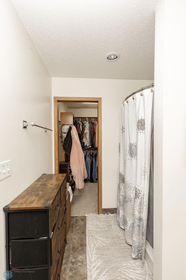 1727 33rd St S, Moorhead, MN 56560 - full bathroom featuring a textured ceiling, curtained shower, and a walk in closet