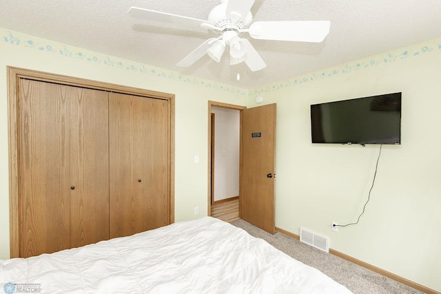 1727 33rd St S, Moorhead, MN 56560 - bedroom featuring a closet, carpet, baseboards, ceiling fan, and a textured ceiling