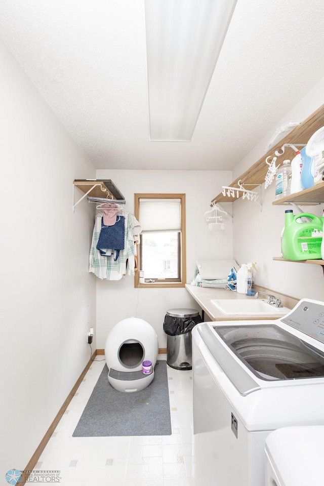 1727 33rd St S, Moorhead, MN 56560 - laundry room with washing machine and dryer, baseboards, and tile patterned floors