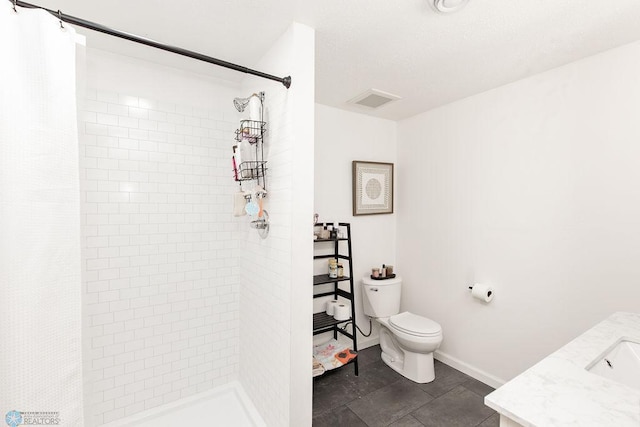 1727 33rd St S, Moorhead, MN 56560 - bathroom featuring tiled shower, toilet, vanity, tile patterned flooring, and baseboards