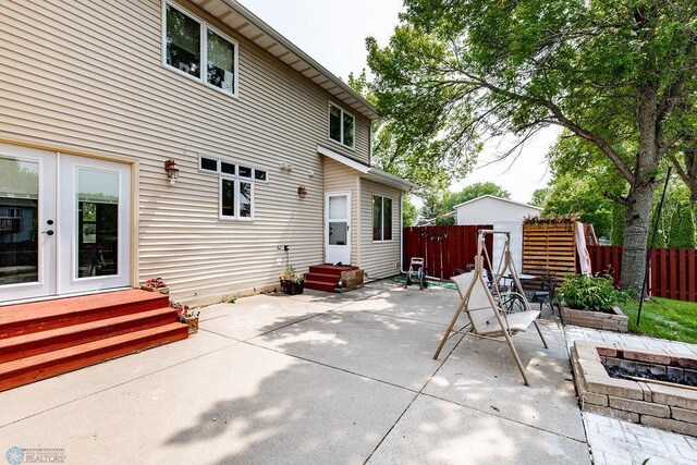 1727 33rd St S, Moorhead, MN 56560 - view of patio featuring an outdoor fire pit, entry steps, and french doors