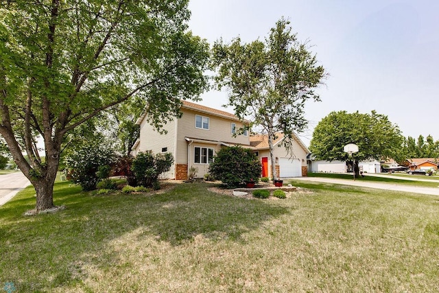 1727 33rd St S, Moorhead, MN 56560 - obstructed view of property featuring concrete driveway, a front lawn, an attached garage, and brick siding