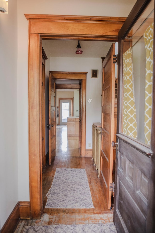 210 6th St, Morris, MN 56267 - corridor with hardwood / wood-style flooring and baseboards