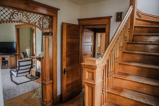 210 6th St, Morris, MN 56267 - stairway featuring arched walkways and wood finished floors