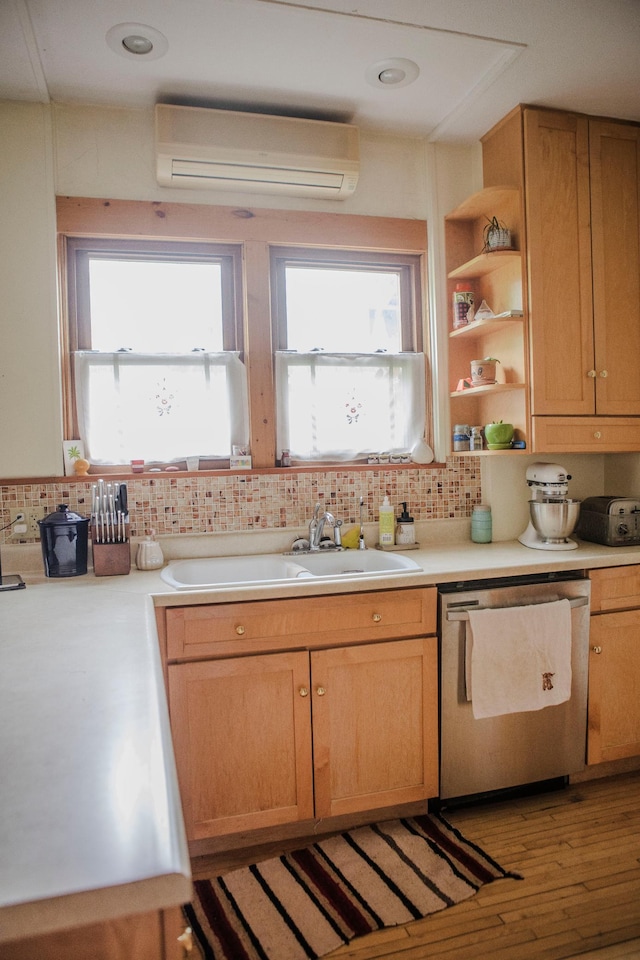 210 6th St, Morris, MN 56267 - kitchen featuring dishwasher, a wall unit AC, a sink, and tasteful backsplash