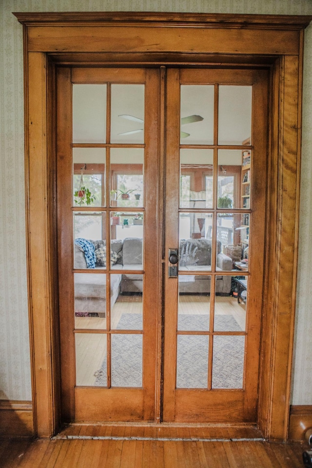 210 6th St, Morris, MN 56267 - detailed view of french doors, wood finished floors, wallpapered walls, and baseboards