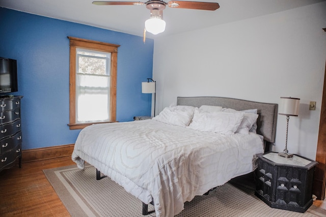 210 6th St, Morris, MN 56267 - bedroom with wood finished floors, baseboards, and ceiling fan