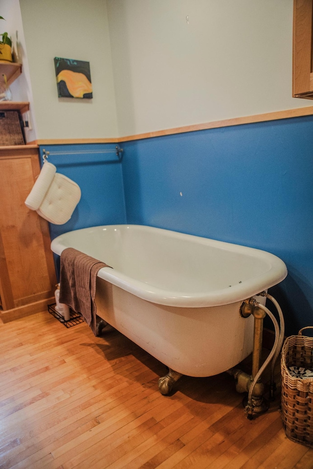 210 6th St, Morris, MN 56267 - bathroom with wood finished floors and a soaking tub