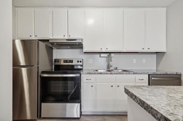4029 14th Ave S Unit 14G, Minneapolis, MN 55407 - kitchen with under cabinet range hood, appliances with stainless steel finishes, a sink, white cabinets, and light wood-style floors