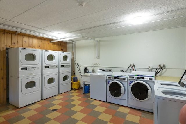 4029 14th Ave S Unit 14G, Minneapolis, MN 55407 - shared laundry featuring washing machine and clothes dryer, light floors, and stacked washing machine and dryer