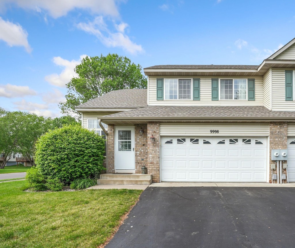 9998 Hamlet Ln S, Cottage Grove, MN 55016 - view of front of home with a garage, asphalt driveway, and brick siding