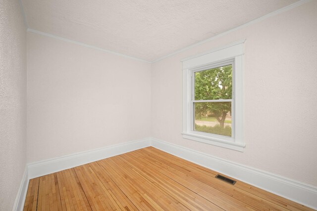 1836 Marshall Ave, Saint Paul, MN 55104 - unfurnished room featuring light wood-style flooring, ornamental molding, and a textured ceiling