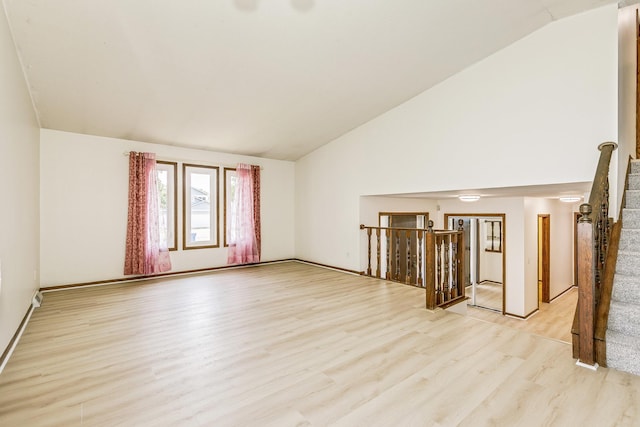 2723 Innsbruck Dr, New Brighton, MN 55112 - unfurnished room featuring lofted ceiling, light wood-type flooring, and stairway