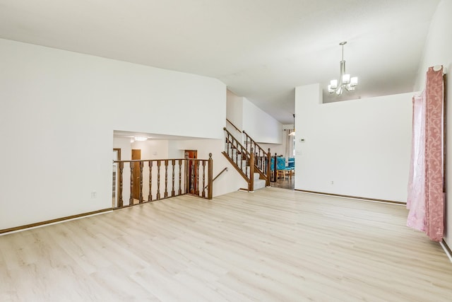 2723 Innsbruck Dr, New Brighton, MN 55112 - unfurnished room with a chandelier, wood finished floors, lofted ceiling, and stairway