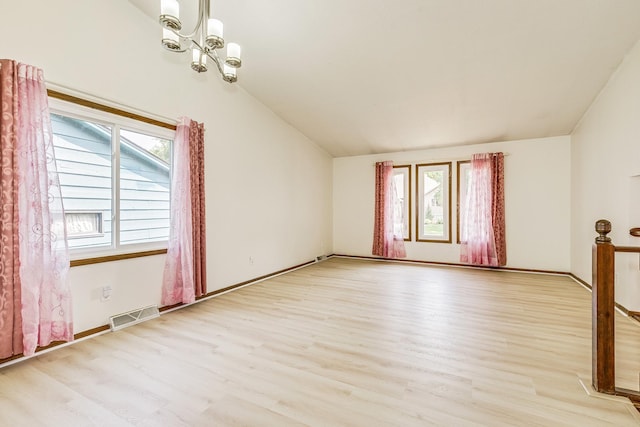 2723 Innsbruck Dr, New Brighton, MN 55112 - spare room featuring healthy amount of natural light, wood finished floors, vaulted ceiling, and baseboards