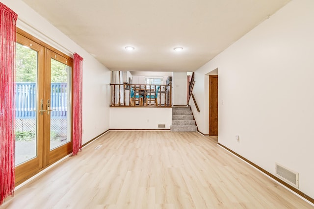 2723 Innsbruck Dr, New Brighton, MN 55112 - empty room featuring light wood-style floors, french doors, stairway, recessed lighting, and baseboards