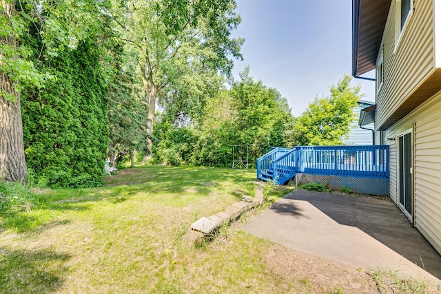 2723 Innsbruck Dr, New Brighton, MN 55112 - view of green lawn featuring a wooden deck and a patio