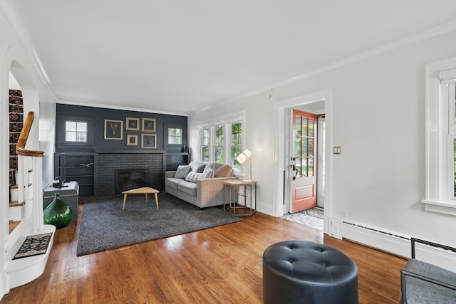 4848 Ewing Ave S, Minneapolis, MN 55410 - living area with ornamental molding, wood finished floors, a brick fireplace, and a baseboard heating unit