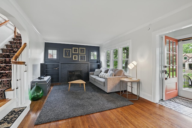 4848 Ewing Ave S, Minneapolis, MN 55410 - living area featuring ornamental molding, plenty of natural light, wood finished floors, stairway, and a fireplace