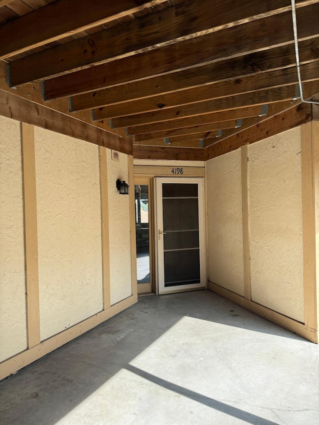 4198 Hilltop Ln, Eagan, MN 55123 - view of exterior entry with stucco siding and a patio area