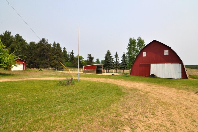 24892 277th Ave, Akeley Twp, MN 56467 - view of grassy yard featuring a barn and an outbuilding