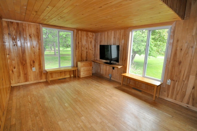 24892 277th Ave, Akeley Twp, MN 56467 - unfurnished living room with light wood-style floors, wood walls, and wood ceiling