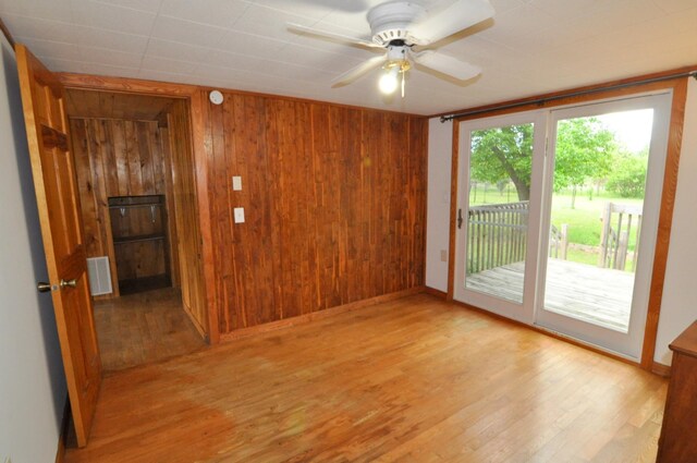 24892 277th Ave, Akeley Twp, MN 56467 - empty room with wood finished floors, wood walls, and a ceiling fan