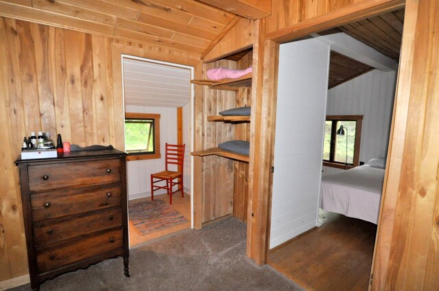 24892 277th Ave, Akeley Twp, MN 56467 - bedroom with lofted ceiling, wood walls, and carpet