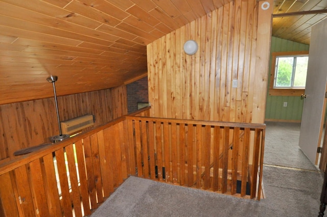 24892 277th Ave, Akeley Twp, MN 56467 - hall featuring vaulted ceiling, wood ceiling, wood walls, an upstairs landing, and carpet floors