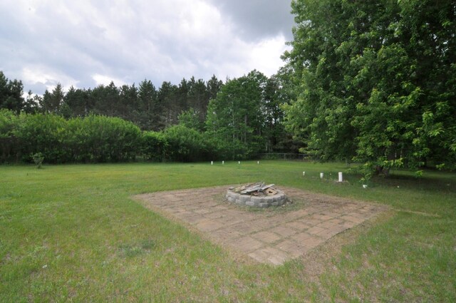 24892 277th Ave, Akeley Twp, MN 56467 - view of green lawn with a fire pit and a patio