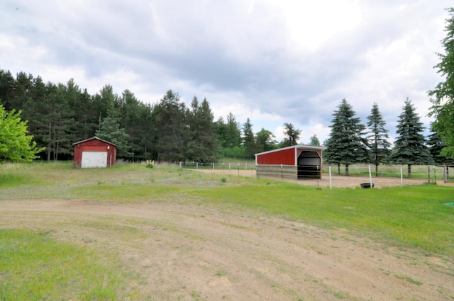 24892 277th Ave, Akeley Twp, MN 56467 - view of yard featuring an outdoor structure, a detached garage, and a pole building