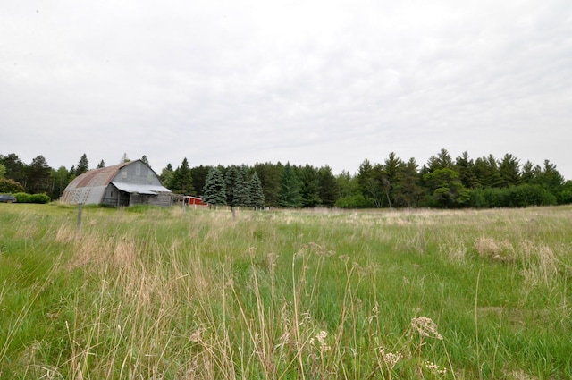 24892 277th Ave, Akeley Twp, MN 56467 - view of yard with a barn, an outbuilding, a forest view, and a view of rural / pastoral area