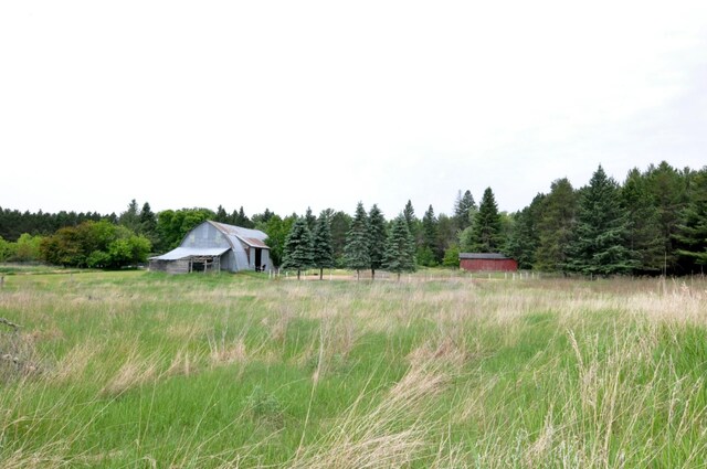24892 277th Ave, Akeley Twp, MN 56467 - view of yard featuring a forest view, an outbuilding, and a rural view