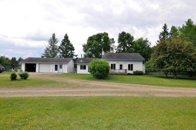 24892 277th Ave, Akeley Twp, MN 56467 - view of front of property with dirt driveway, an outdoor structure, a garage, a front yard, and a deck