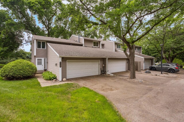 9106 Neill Lake Rd, Eden Prairie, MN 55347 - mid-century inspired home featuring driveway, a garage, and a shingled roof
