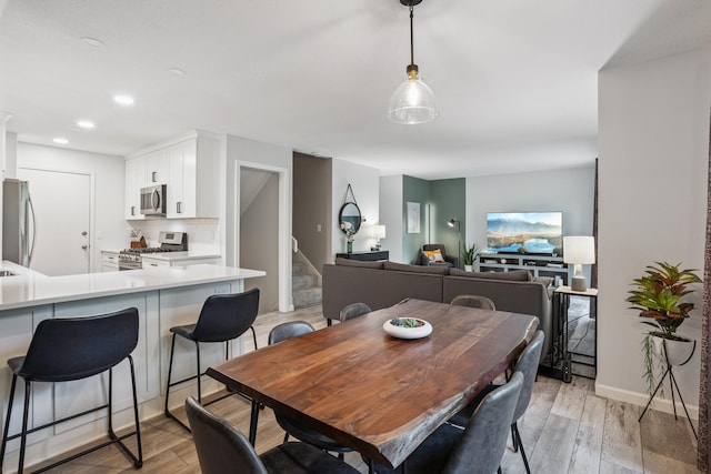 9106 Neill Lake Rd, Eden Prairie, MN 55347 - dining room with stairs, light wood-type flooring, and recessed lighting