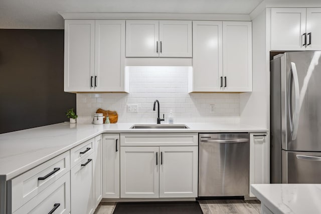 9106 Neill Lake Rd, Eden Prairie, MN 55347 - kitchen featuring appliances with stainless steel finishes, white cabinetry, and tasteful backsplash
