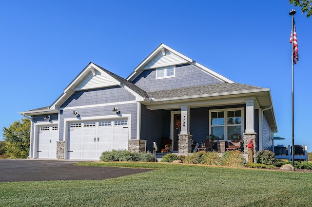 7720 242nd St, Wyoming, MN 55025 - craftsman-style house with a porch, a garage, a front lawn, asphalt driveway, and stone siding
