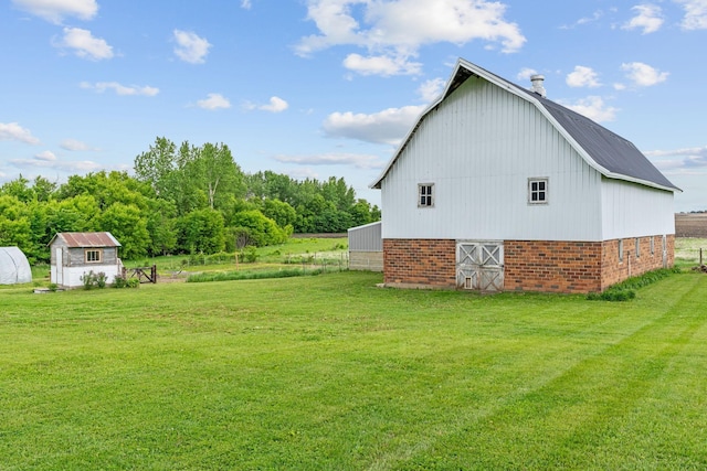 27151 Aberdeen Ave, New Prague, MN 56071 - view of side of home featuring a barn, an outdoor structure, a yard, and brick siding