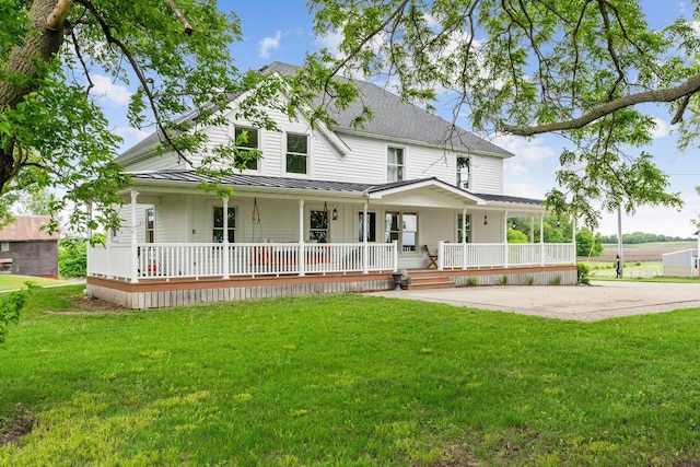 27151 Aberdeen Ave, New Prague, MN 56071 - rear view of house featuring a standing seam roof, covered porch, metal roof, and a lawn