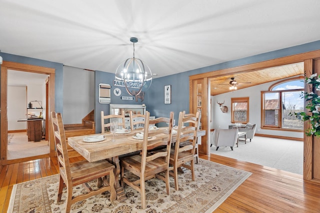 27151 Aberdeen Ave, New Prague, MN 56071 - dining space featuring stairway, a chandelier, light wood-style floors, and vaulted ceiling
