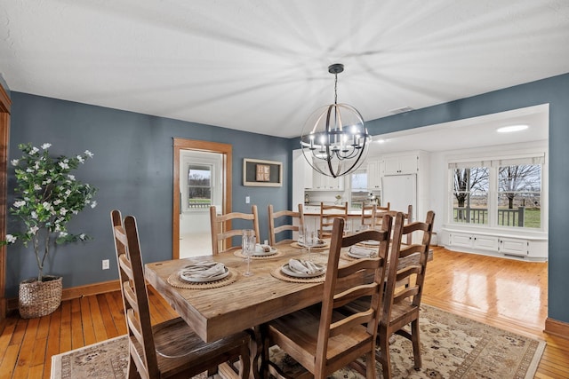 27151 Aberdeen Ave, New Prague, MN 56071 - dining space with a chandelier, light wood-style floors, and baseboards