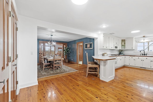 27151 Aberdeen Ave, New Prague, MN 56071 - kitchen with a sink, baseboards, white appliances, light wood finished floors, and recessed lighting