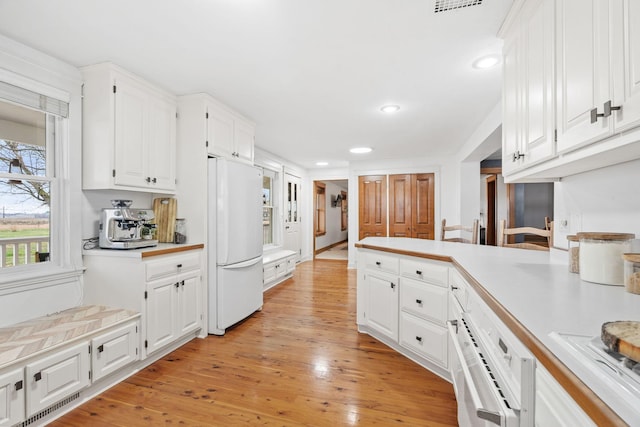 27151 Aberdeen Ave, New Prague, MN 56071 - kitchen featuring freestanding refrigerator, white cabinetry, light countertops, recessed lighting, and light wood finished floors