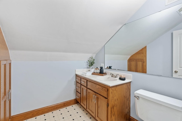 27151 Aberdeen Ave, New Prague, MN 56071 - bathroom featuring lofted ceiling, vanity, toilet, tile patterned floors, and baseboards